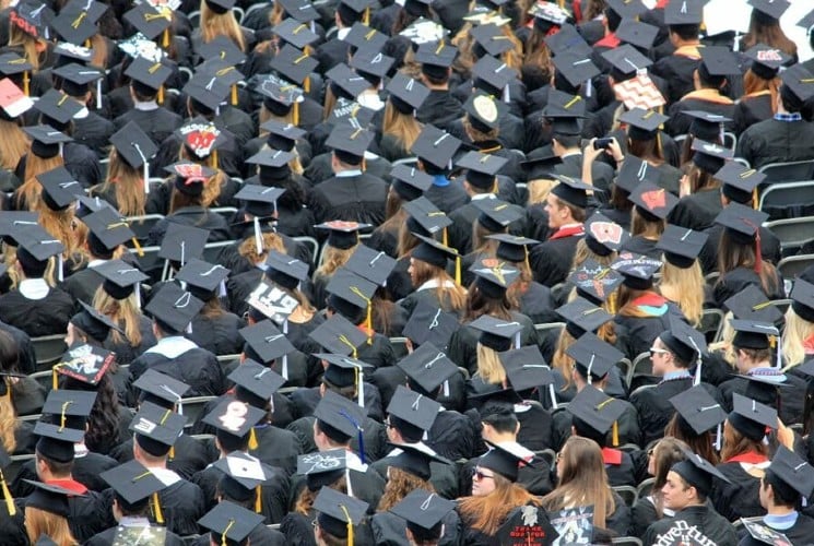A sea of graduates together with their black hats and tassles