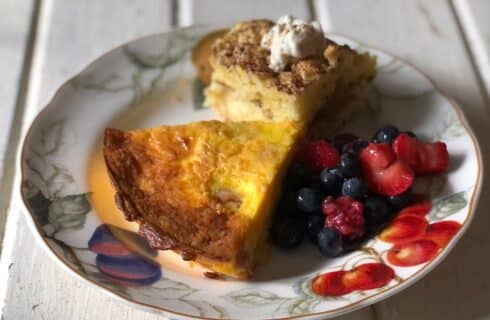 Floral breakfast plate with slice of egg casserole, berries and coffee cake